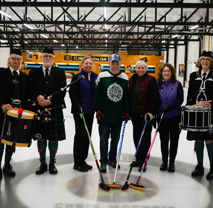 Four curlers particpating in Curl For A Cause joined by members of  Fergus Pipe Band.
